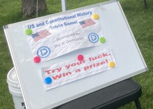 Sign advertising a trivia game awarding prizes for correct answers.